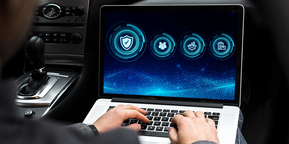 Person on laptop computer sitting in a car