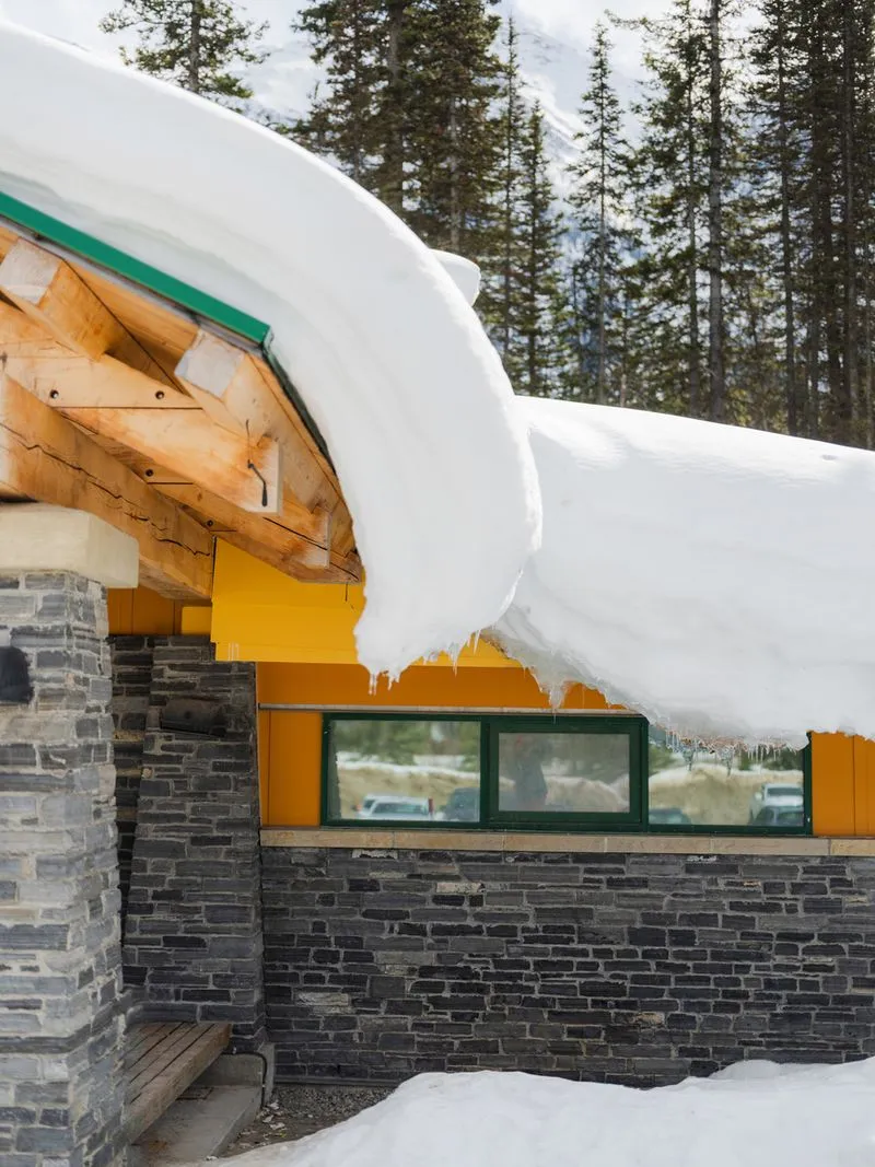 Professional ice dam removal service on Ontario home preventing winter water damage and roof leaks by Lodde Roofing experts using safe removal techniques