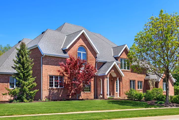 Residential roofing contractors - completed luxury home with laminate shingles by Lodde Roofing - lifetime warranty on architectural shingles