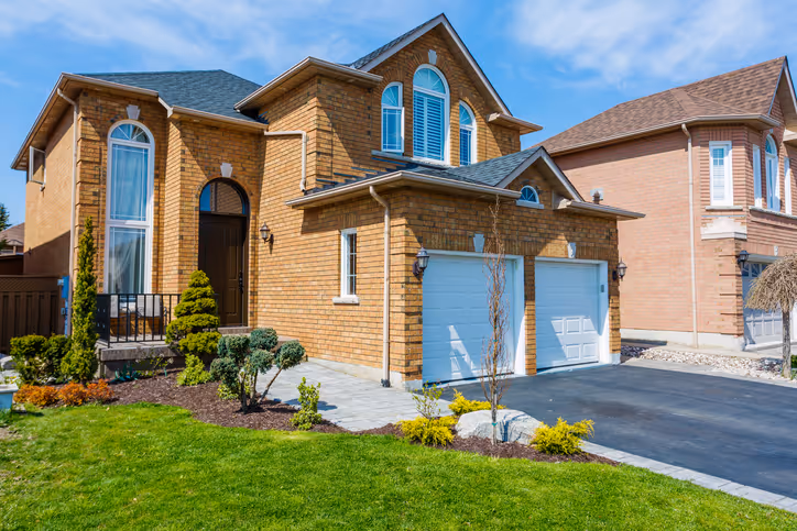 Metal roofing and asphalt shingle installation - modern two-story home by Lodde Roofing contractors - emergency roof repair available
