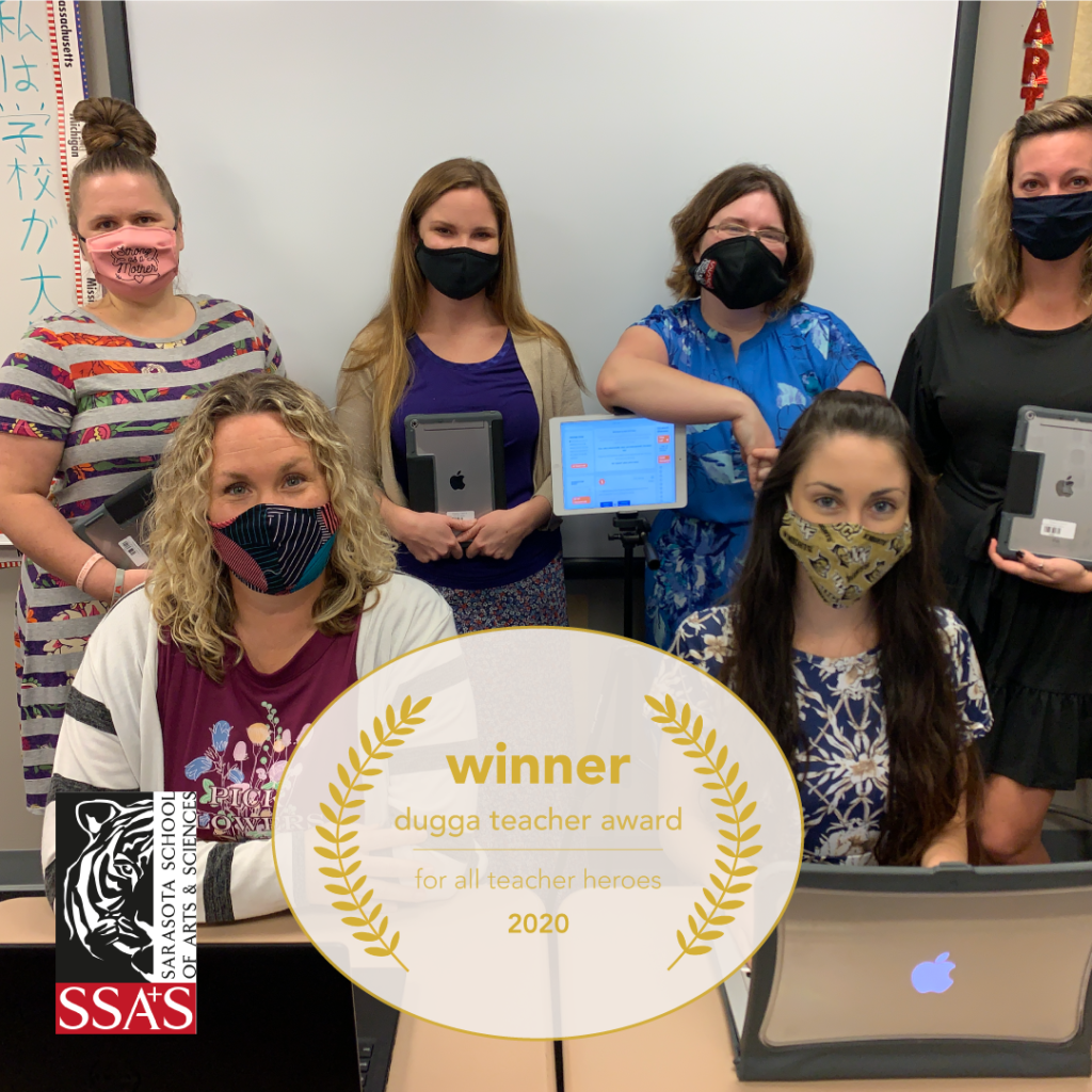 Six masked teachers hold iPads & a laptop in a classroom. SSAS logo. "Dugga Teacher Award 2020" graphic.