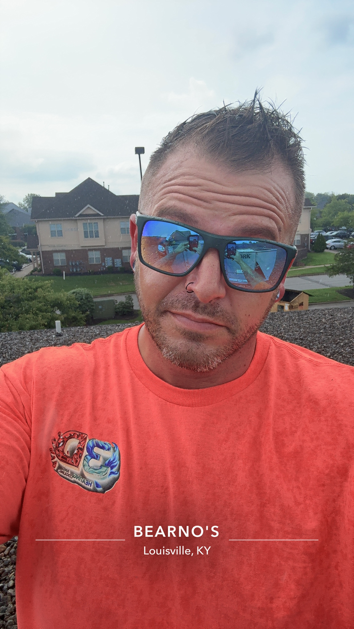 Two workers are discussing electrical schematics.