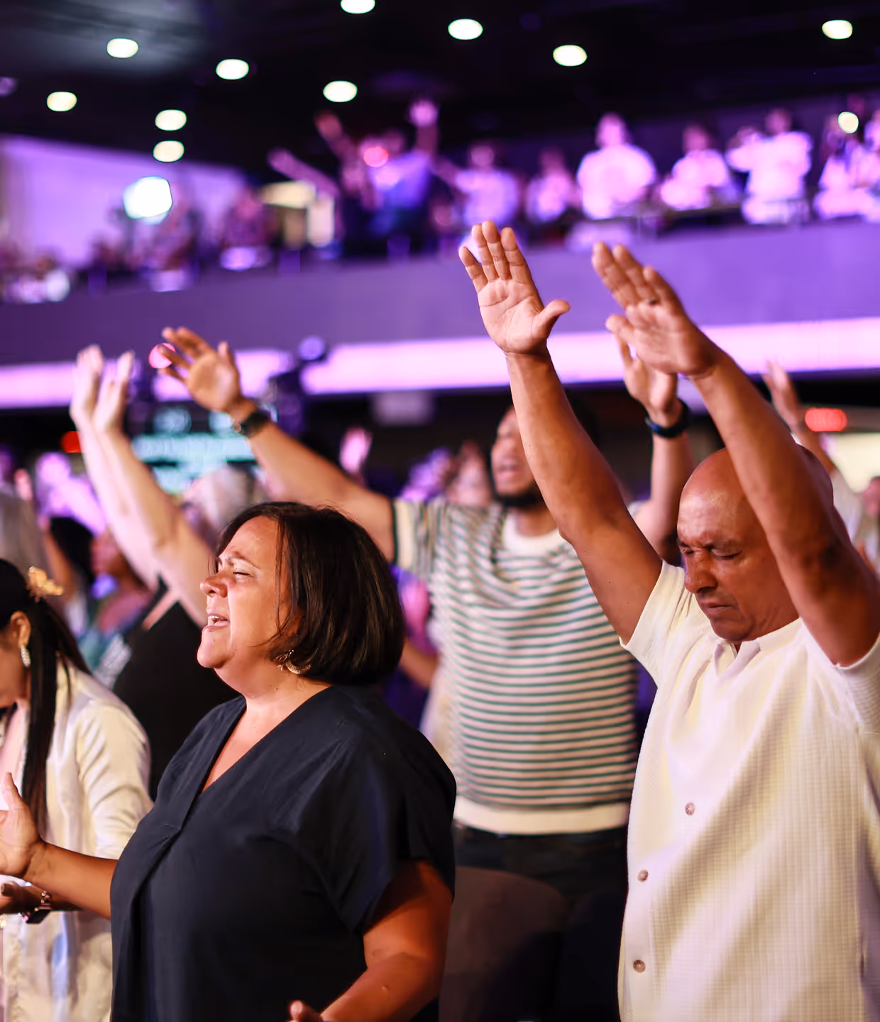paopla attending church service, raising hands