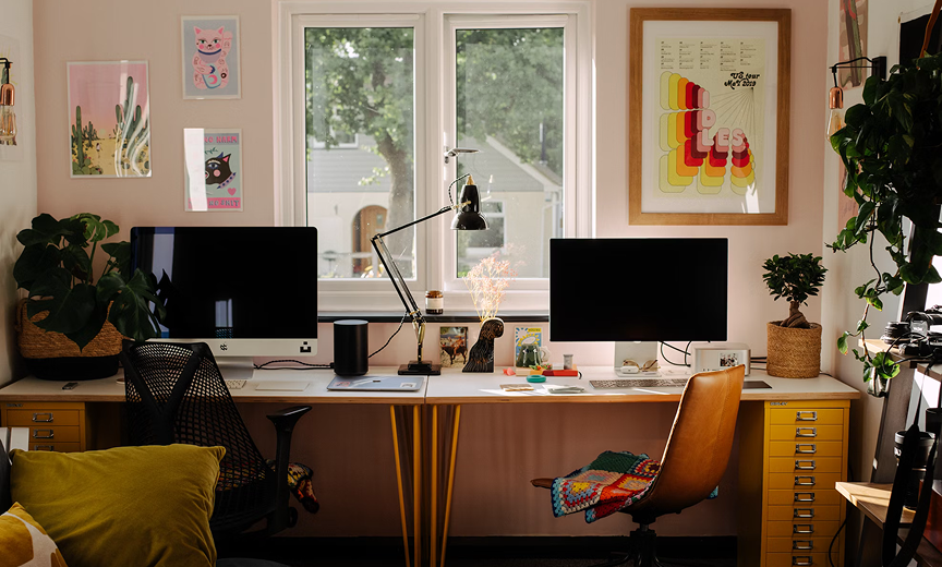a picture of a home office with 2 screens and 2 empty seats