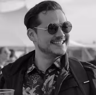 Byron Arreola smiling while wearing sunglasses