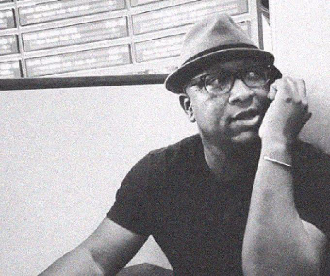 Lester Grant wearing a hat and glasses