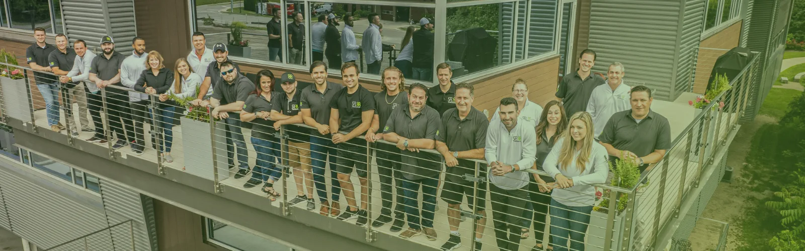 SFL Team posing for a picture on a office balcony