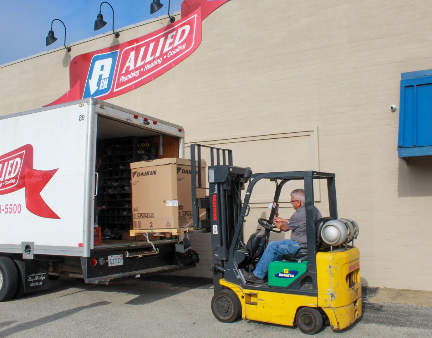 Technician performing a descaling flush on a tankless water heater - how does a tankless water heater work