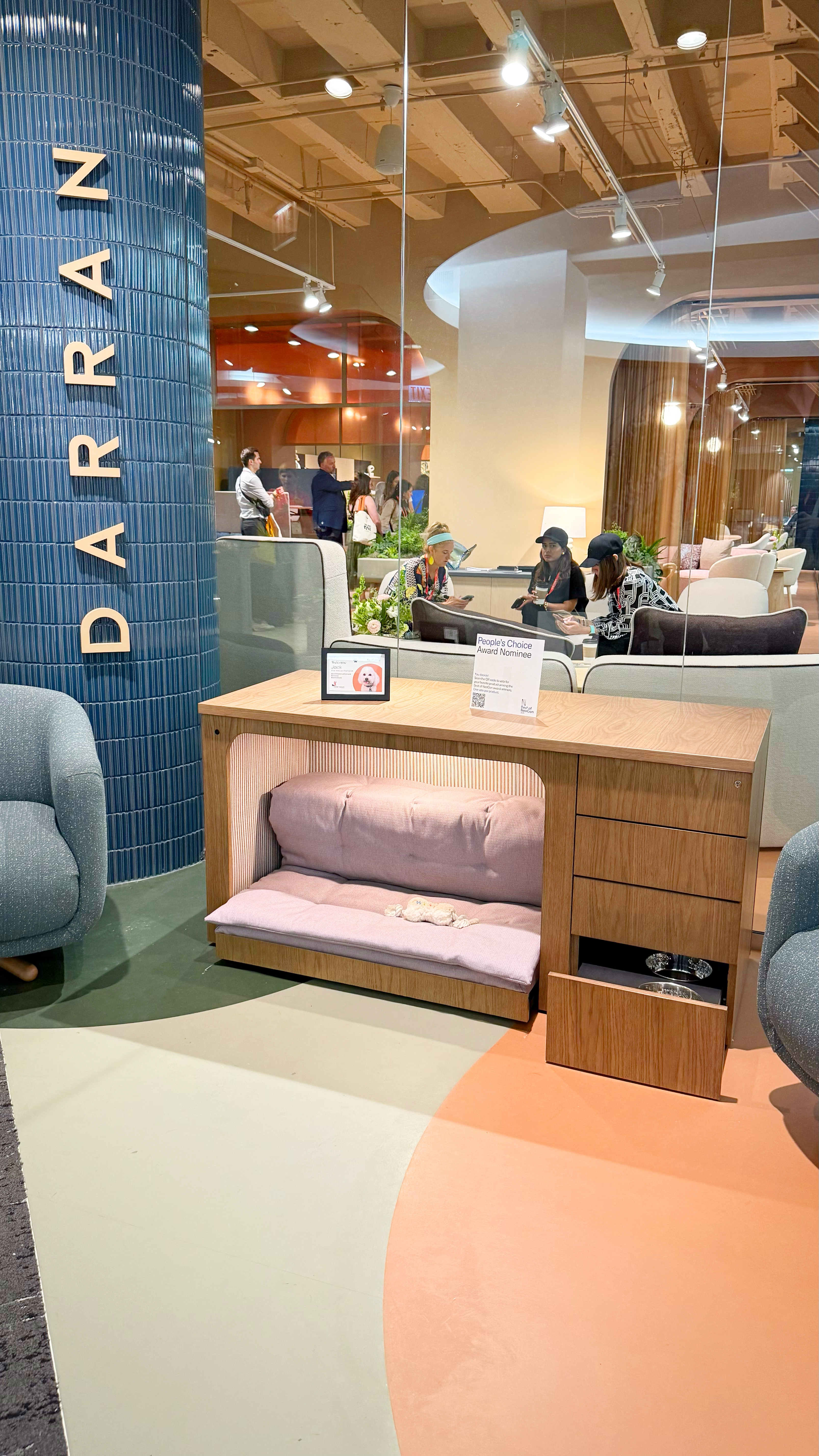 A desk looking structure with a built-in dog bed underneath.