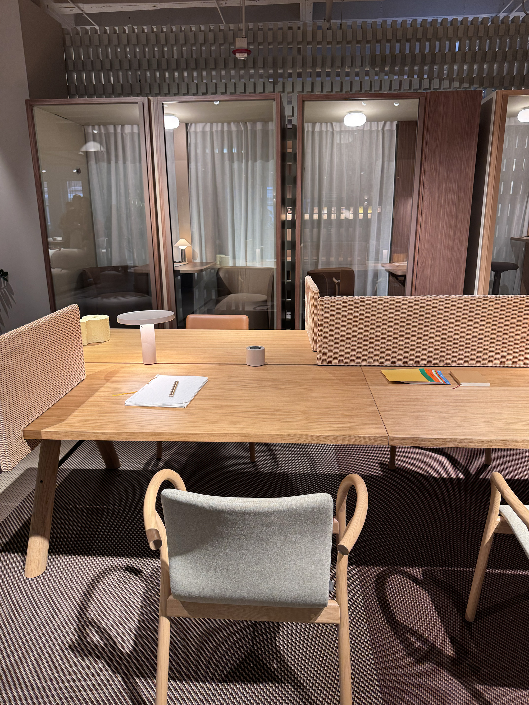 Wicker sheet attached to a desk to provide privacy.