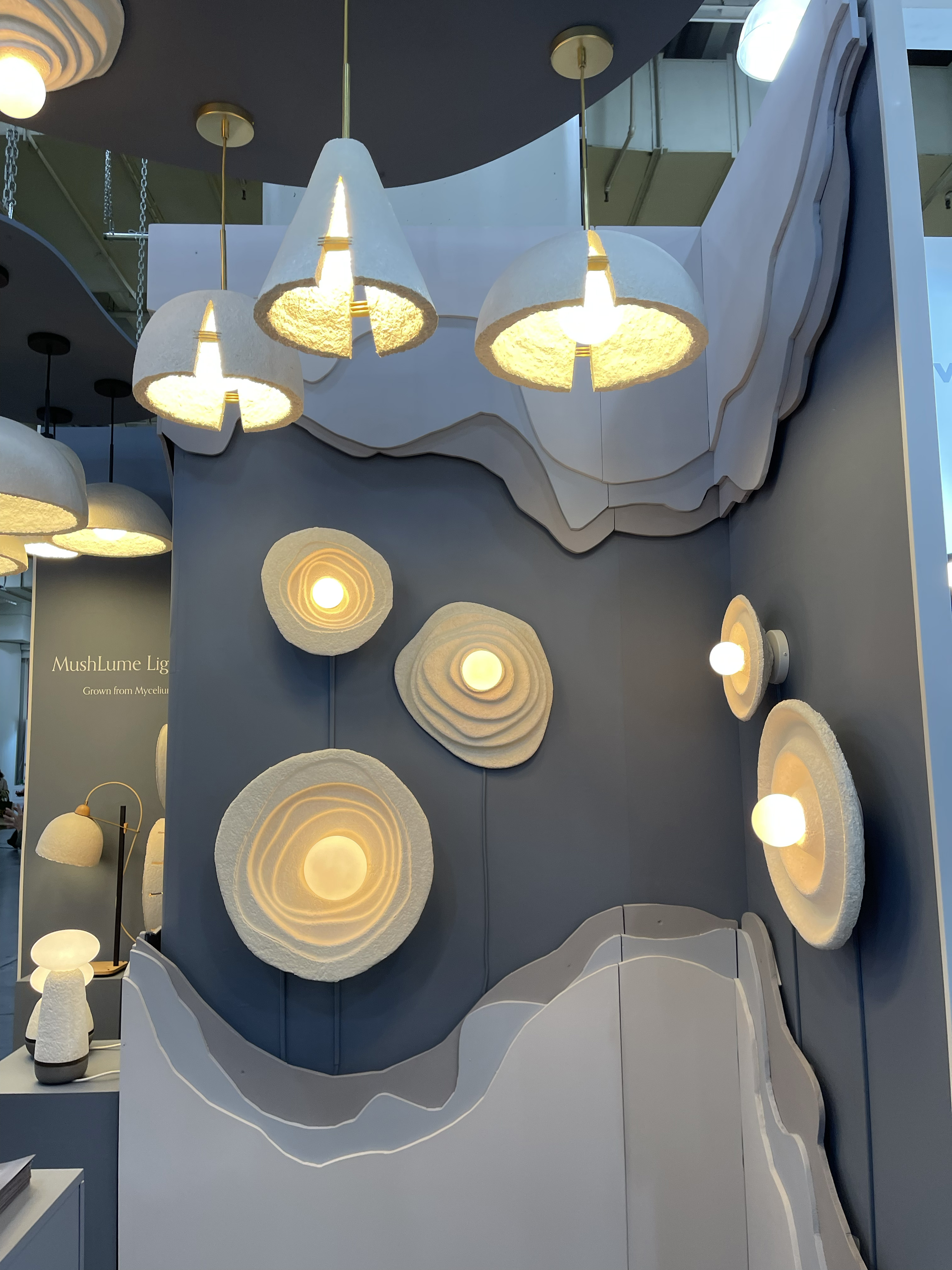 White texture sconces made from mycellium, hanging on a wall.