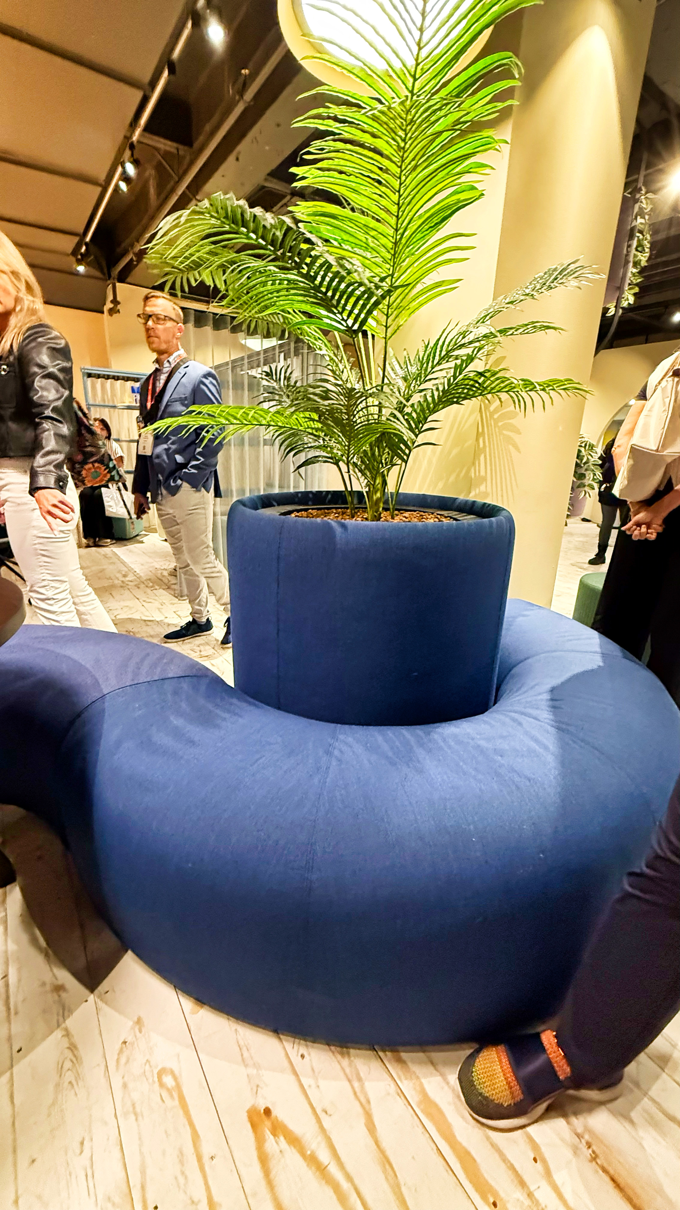 Blue padded benches that wrap around a blue padded planter..