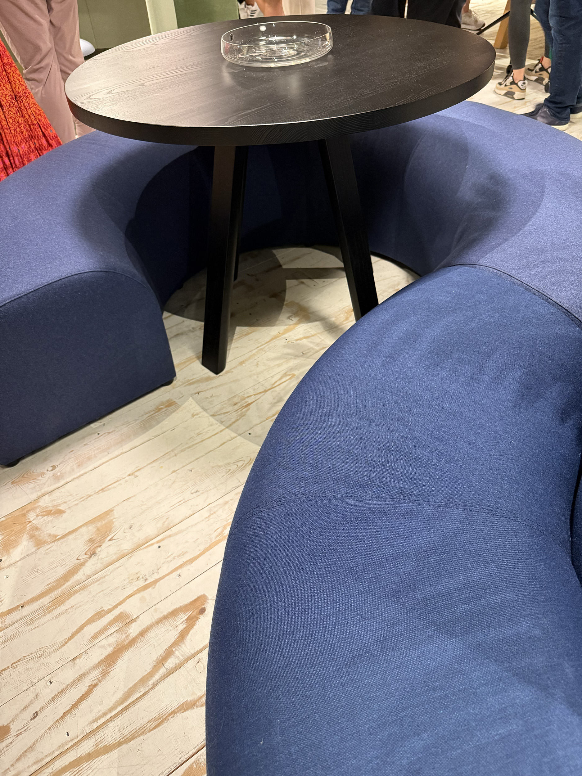 Blue padded benches that wrap around a table.