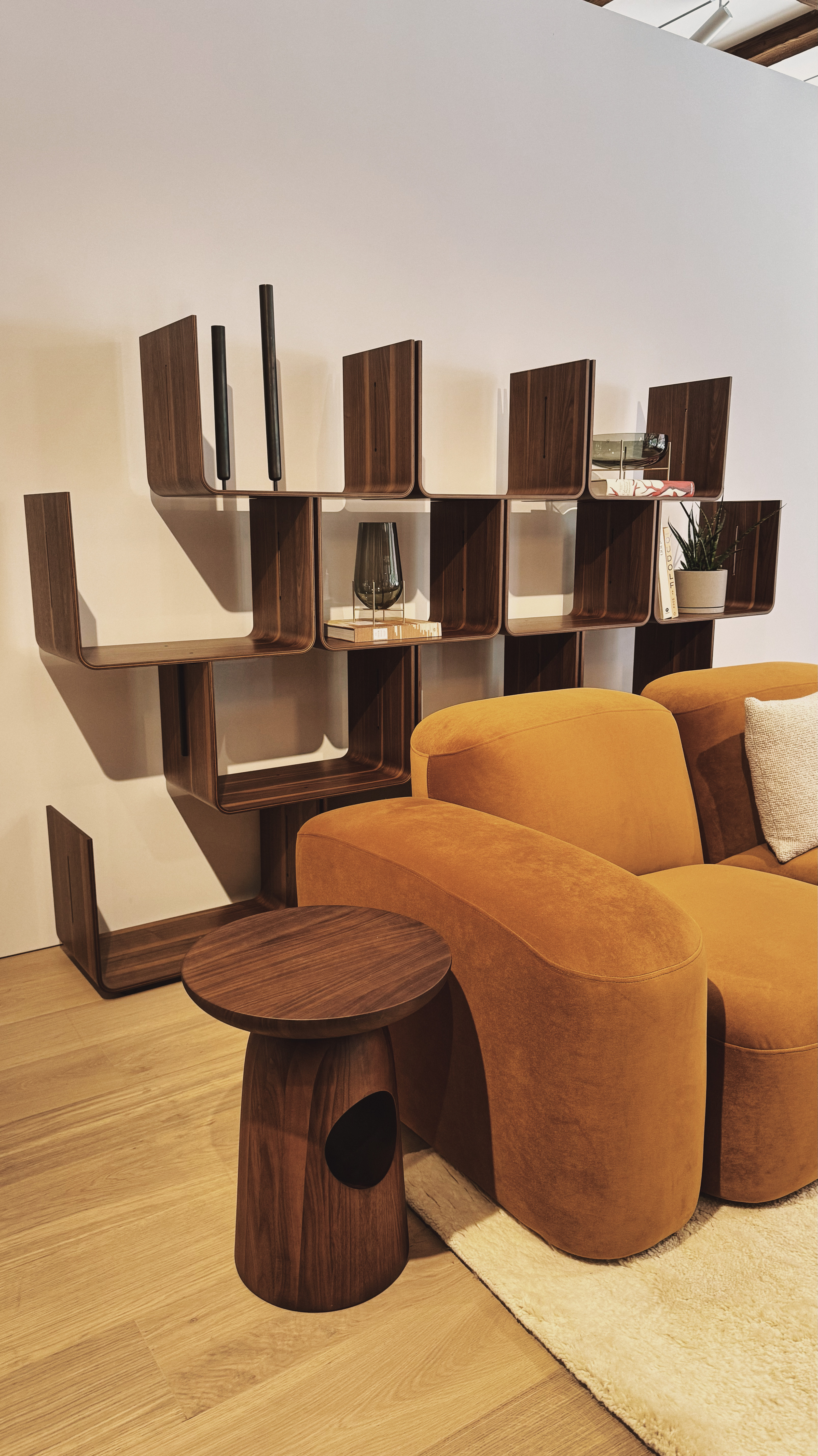 Wooden bookshelves arranged in a repeating U shaped patten.