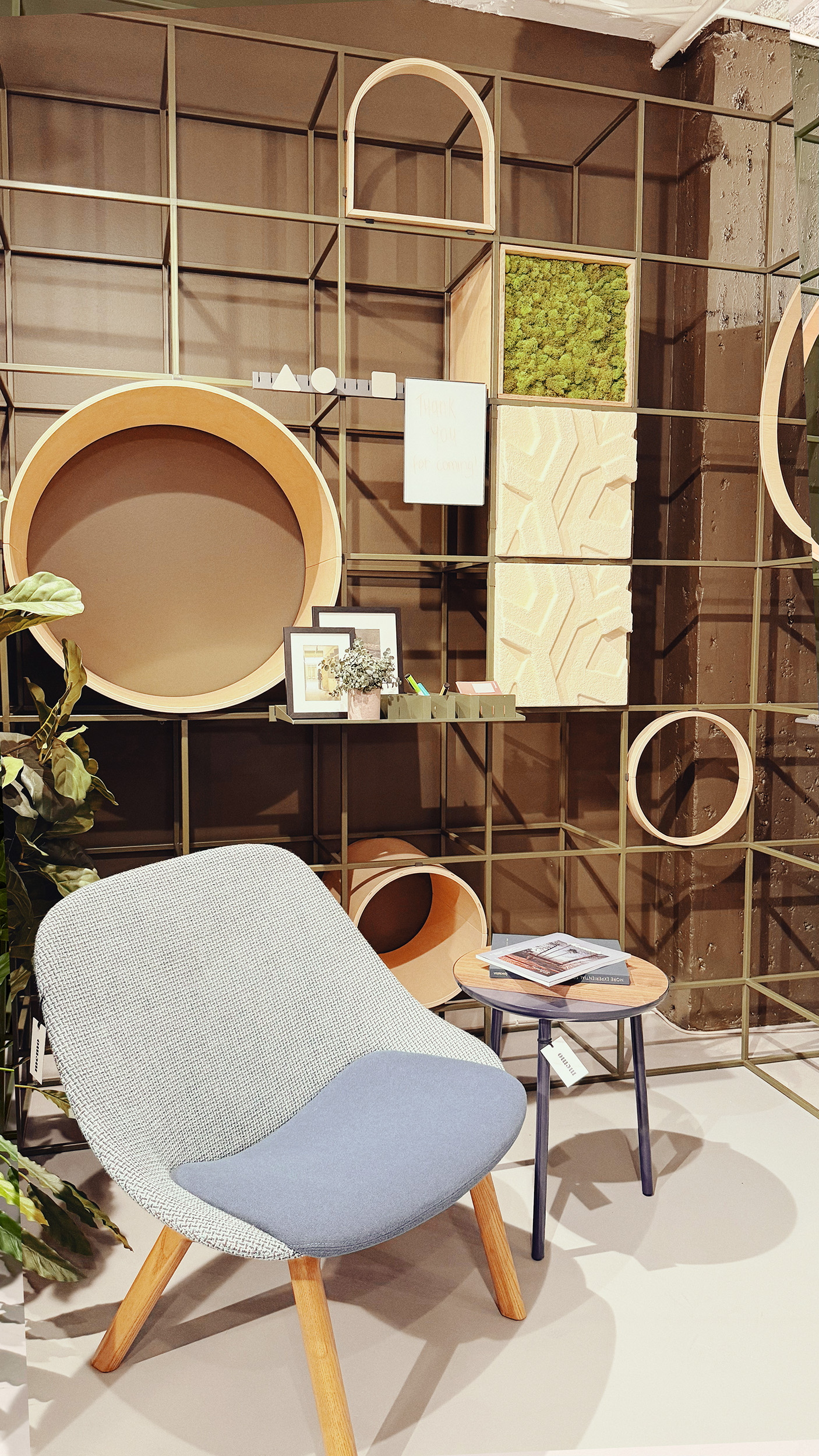 A metal grid like frame with wood cubbies placed into the frame.