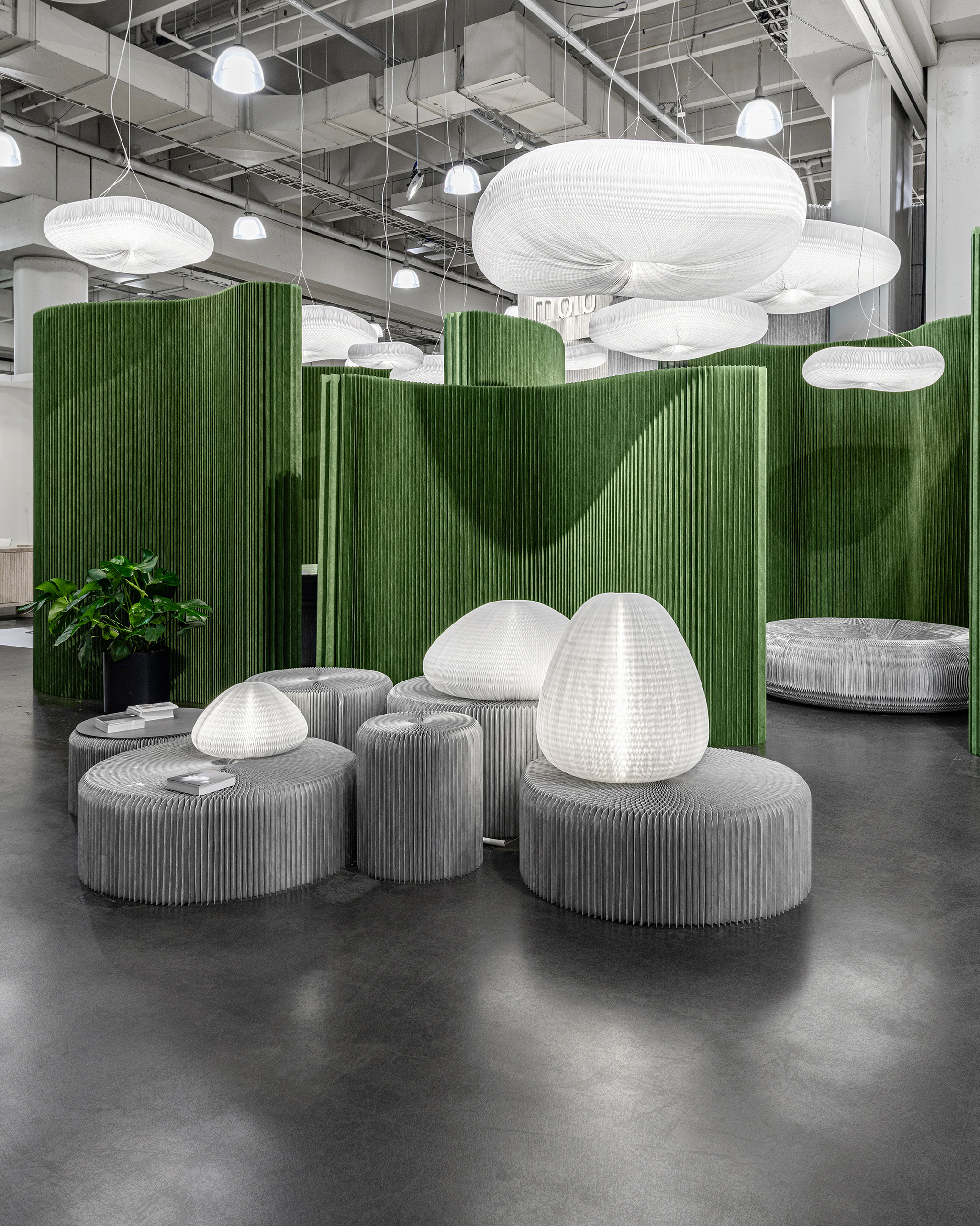 Green accordion paper walls with gray paper accordion seats.