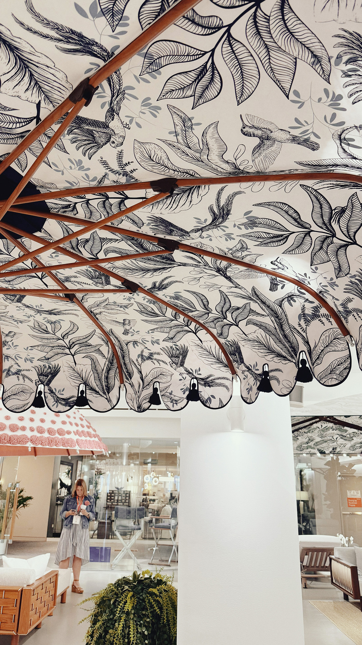 Outdoor umbrella with a palmette print on the underside of the umbrella.