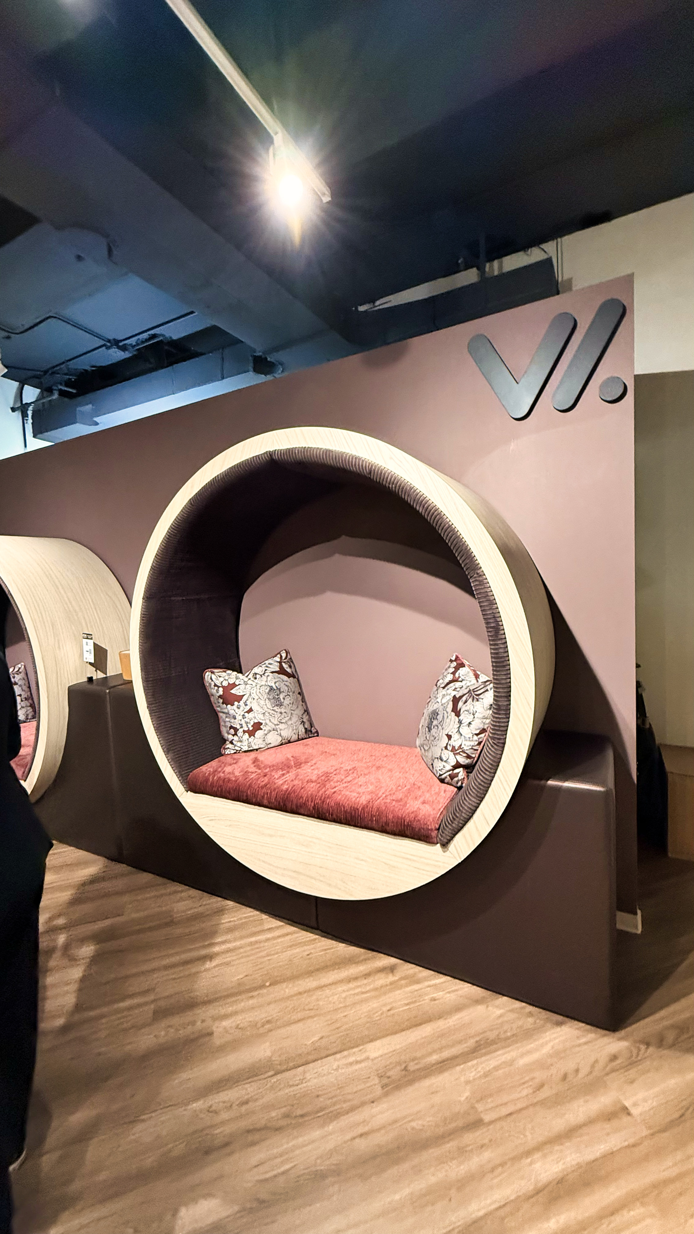 Purple circle against a wall with a pink bench at the bottom.