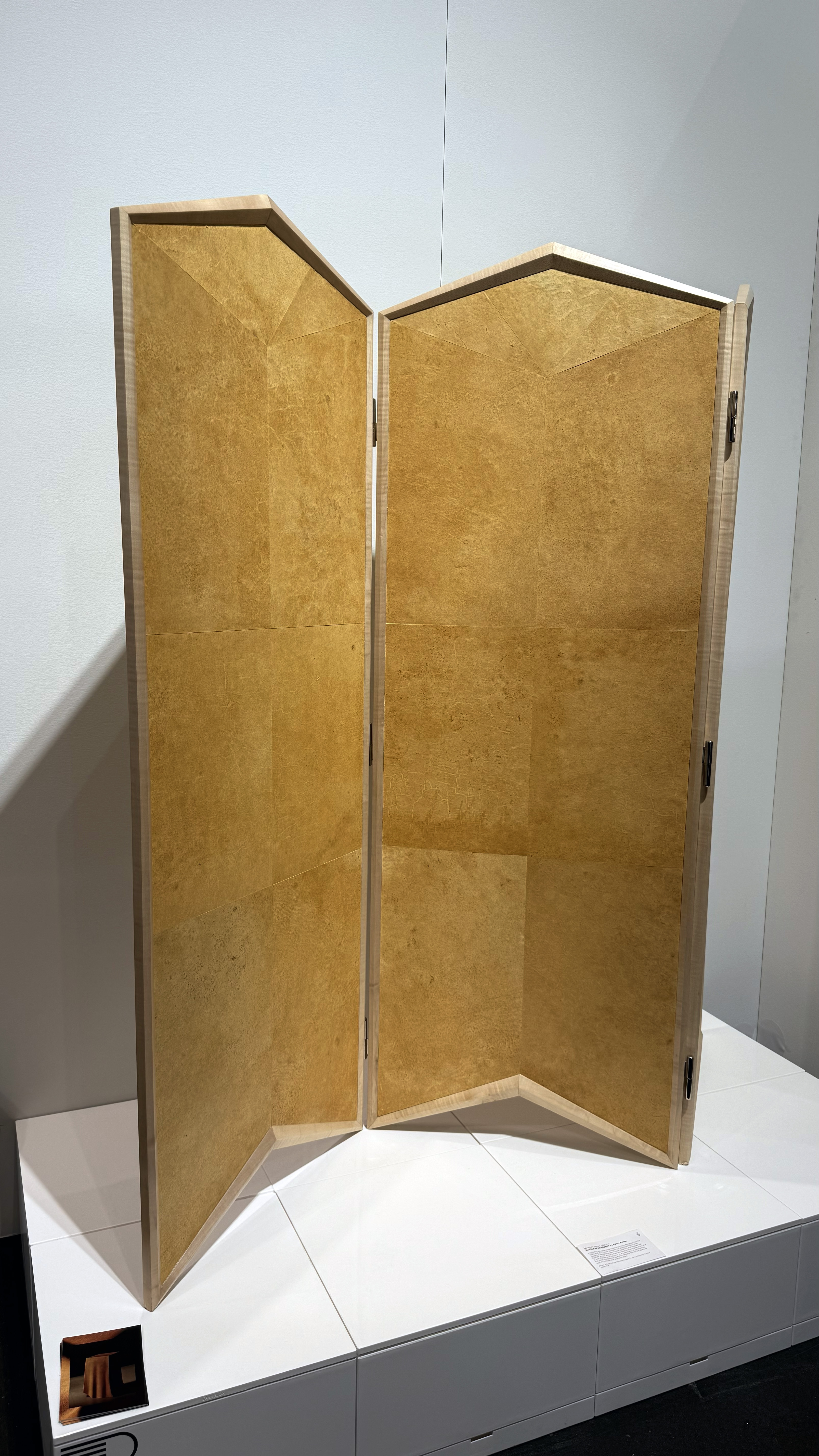 A light brown divider with a wood frame surrounding a yellowish-brown mushroom leather.