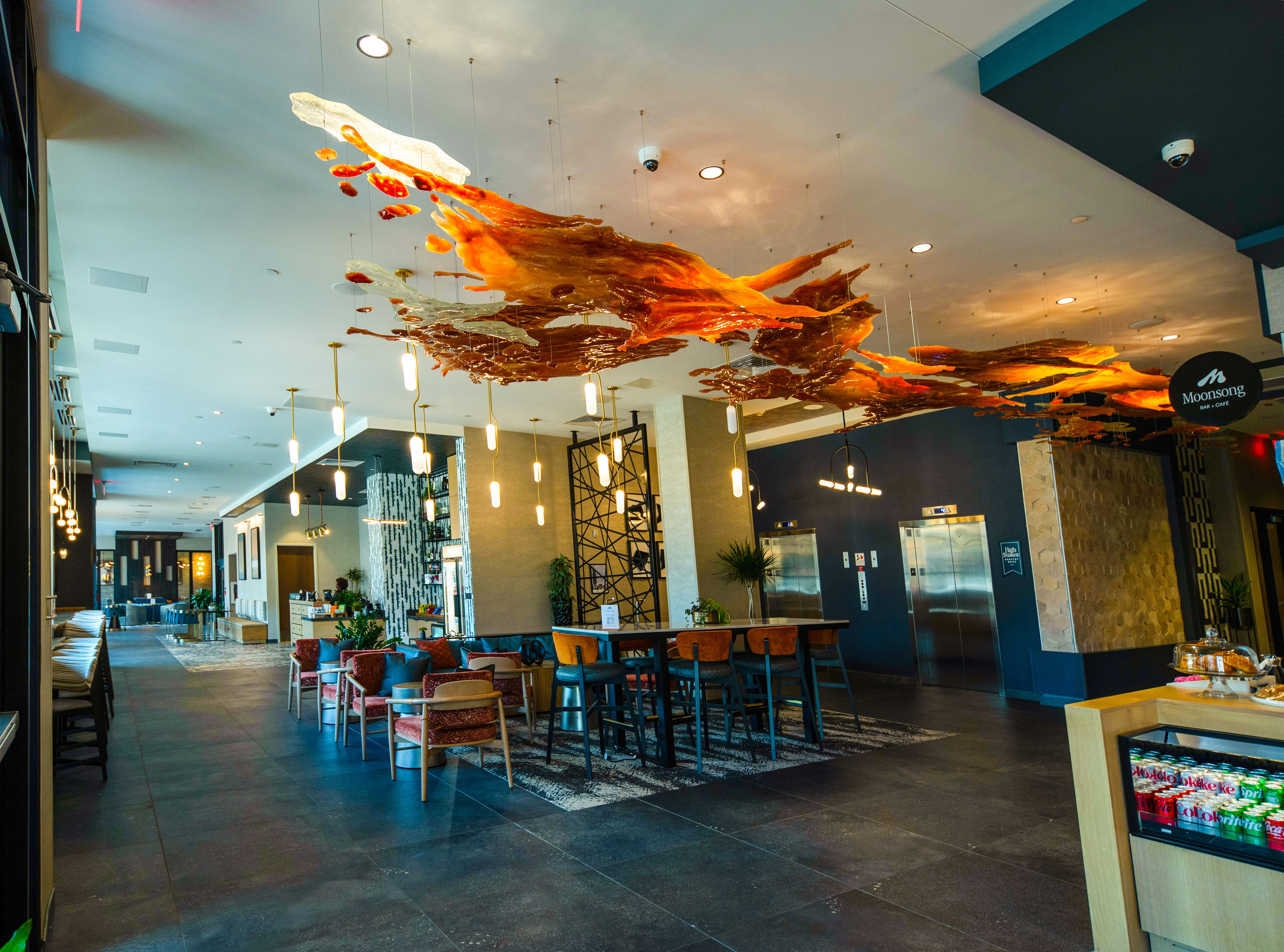 Red and yellow hanging sculpture that gives off the imitation of stretched wax.