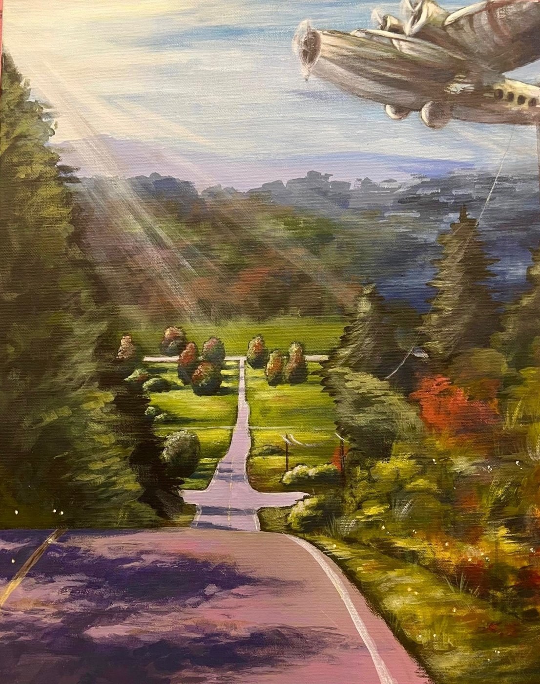Where Engines Once Roared: a road through green hills toward distant mountains, with sunlight breaking through and a vintage plane in the sky