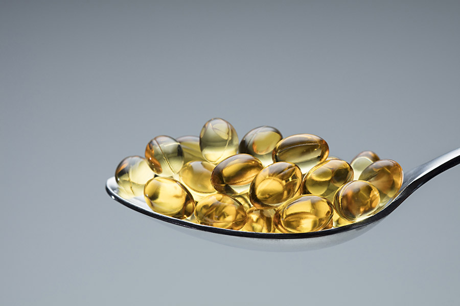 An image featuring a spoonful of multivitamins that contribute to improving brain health in older adults.