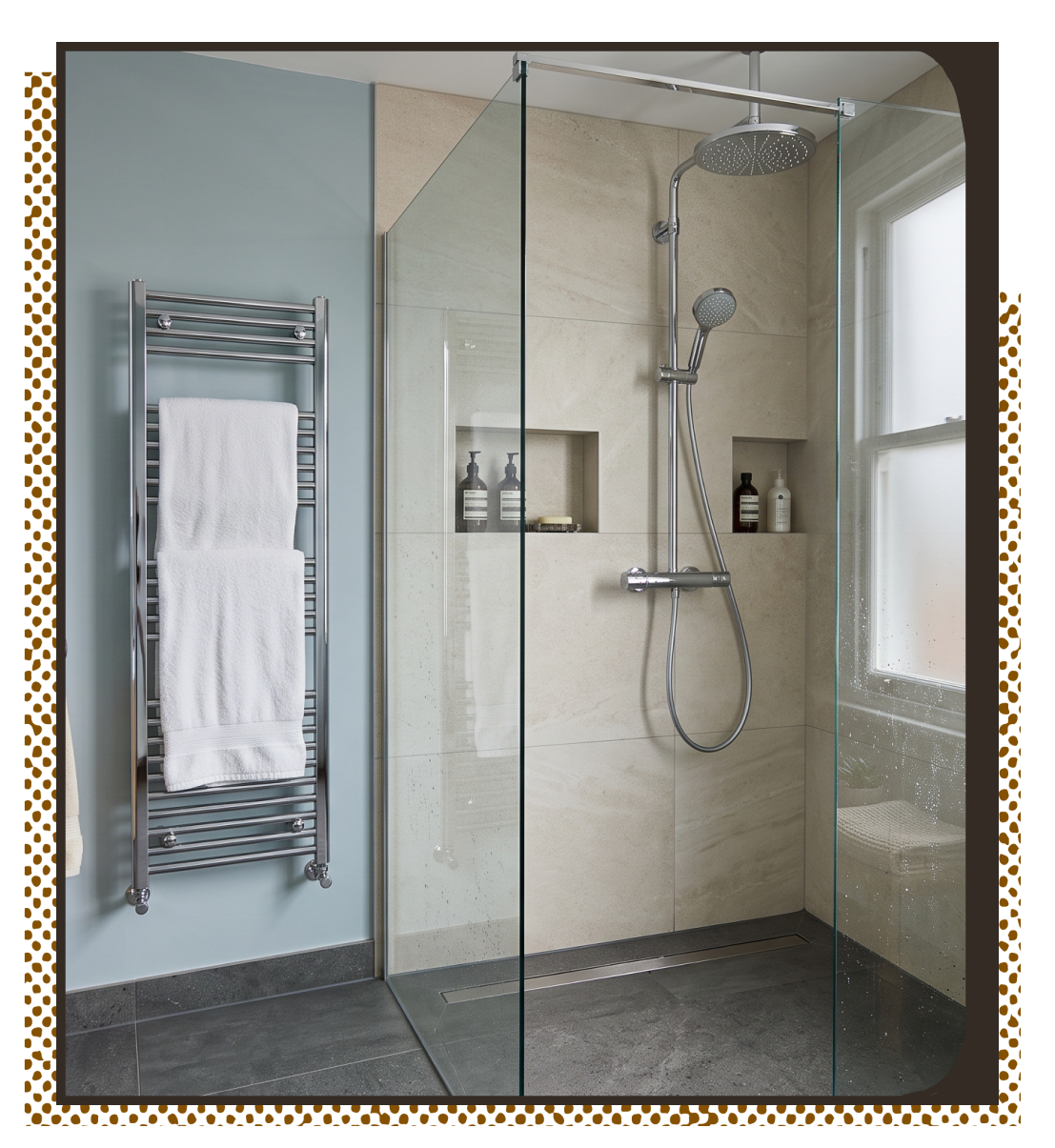 Modern bathroom with curved bathtub, glass shower screen, wall tiles, white toilet, and wooden floor.