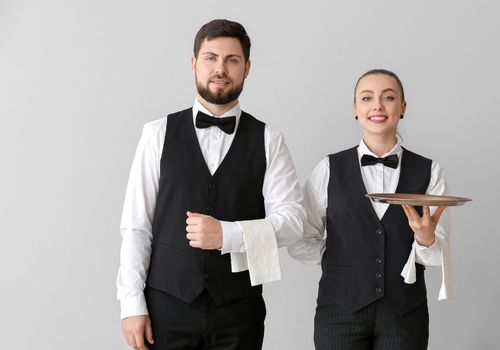 two servers in black uniforms 