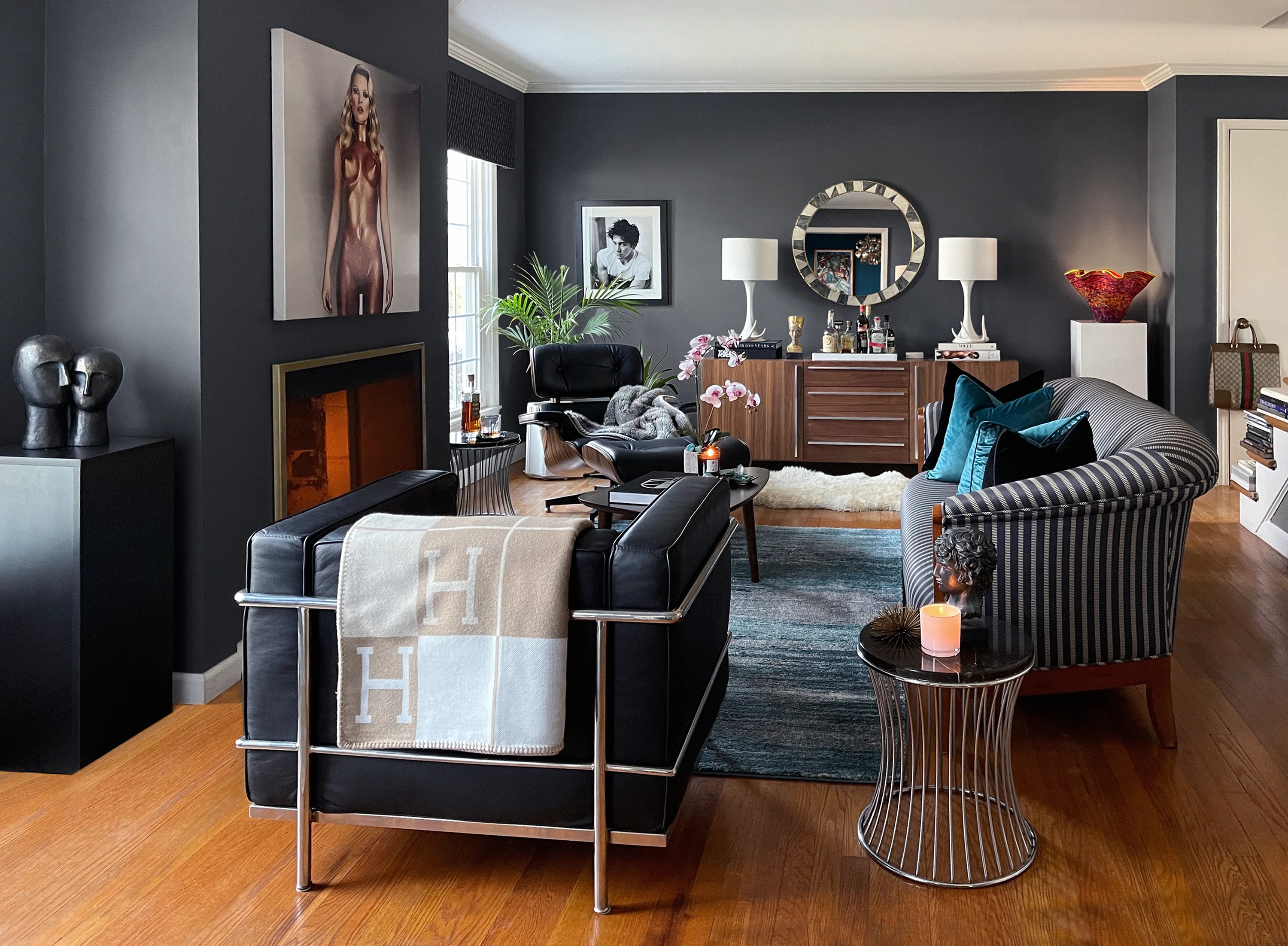 Duncan Phyfe style sofa paired with mid-century chairs in a balanced masculine living room design