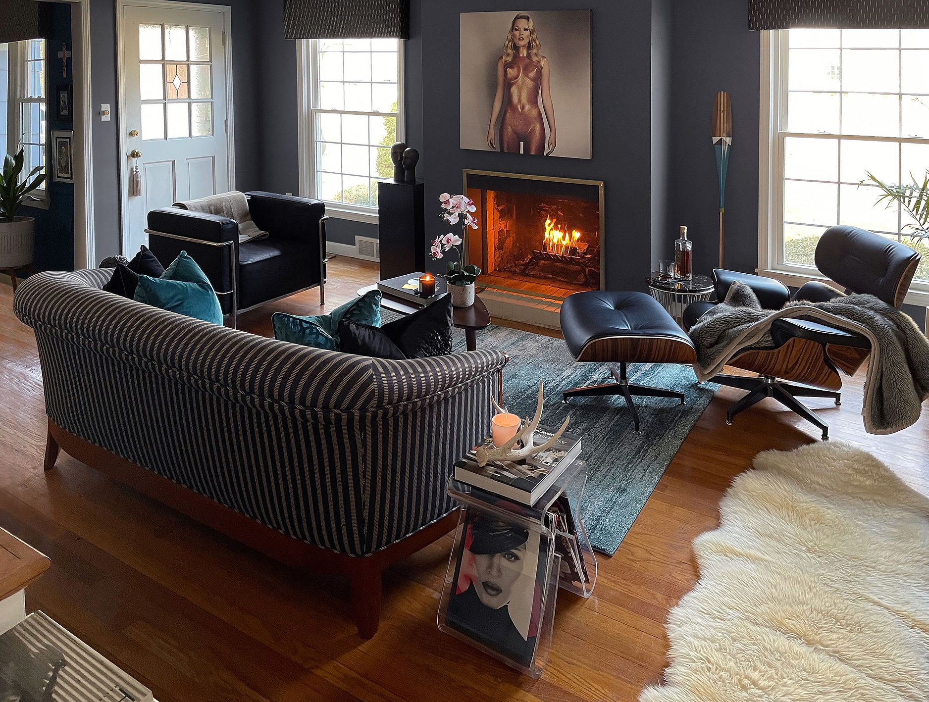 Walnut credenza with white lamps and round mirror creating symmetry in a modern living room