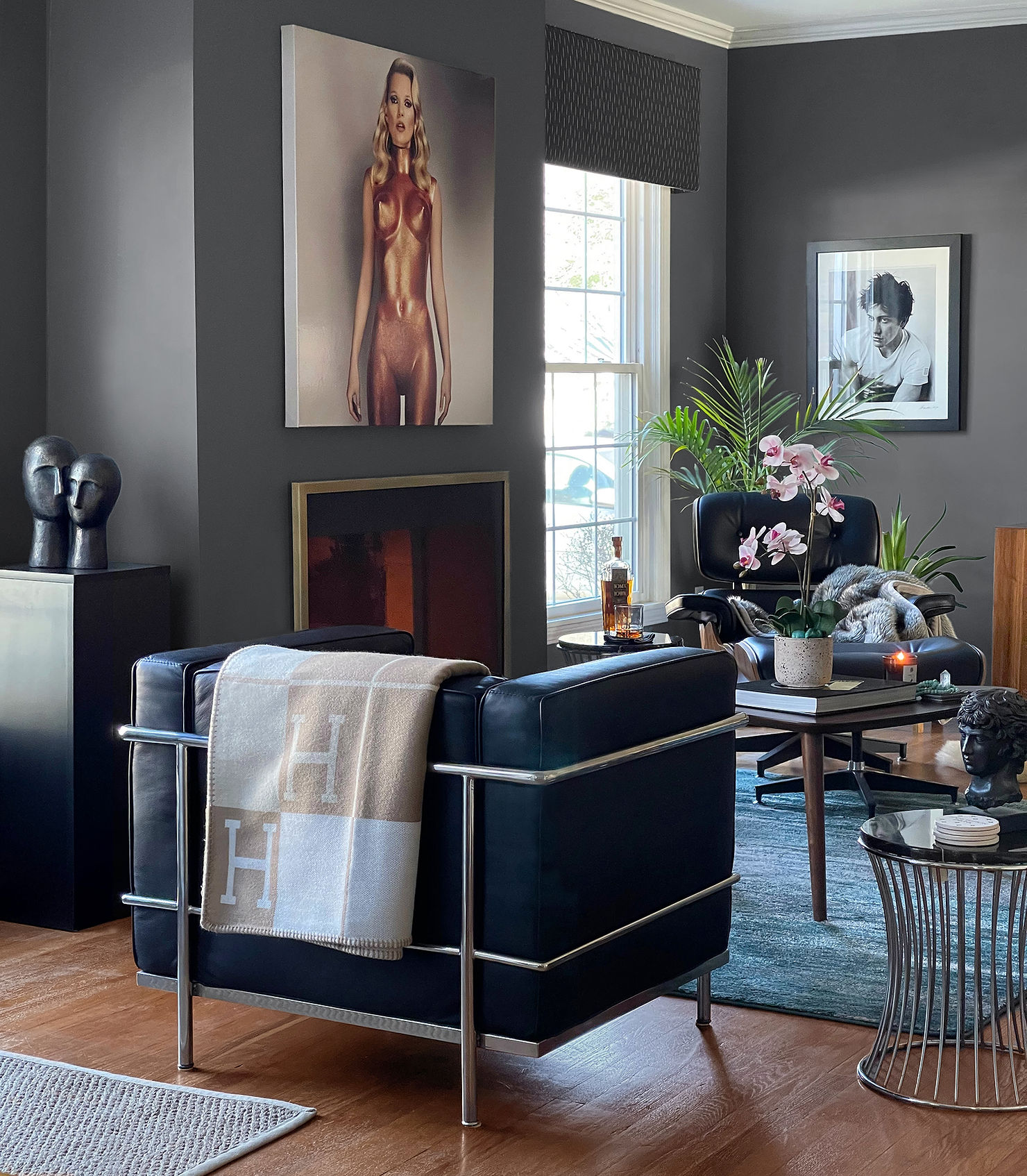 Black-and-white Kate Moss photograph by Allen Jones displayed above a modern fireplace
