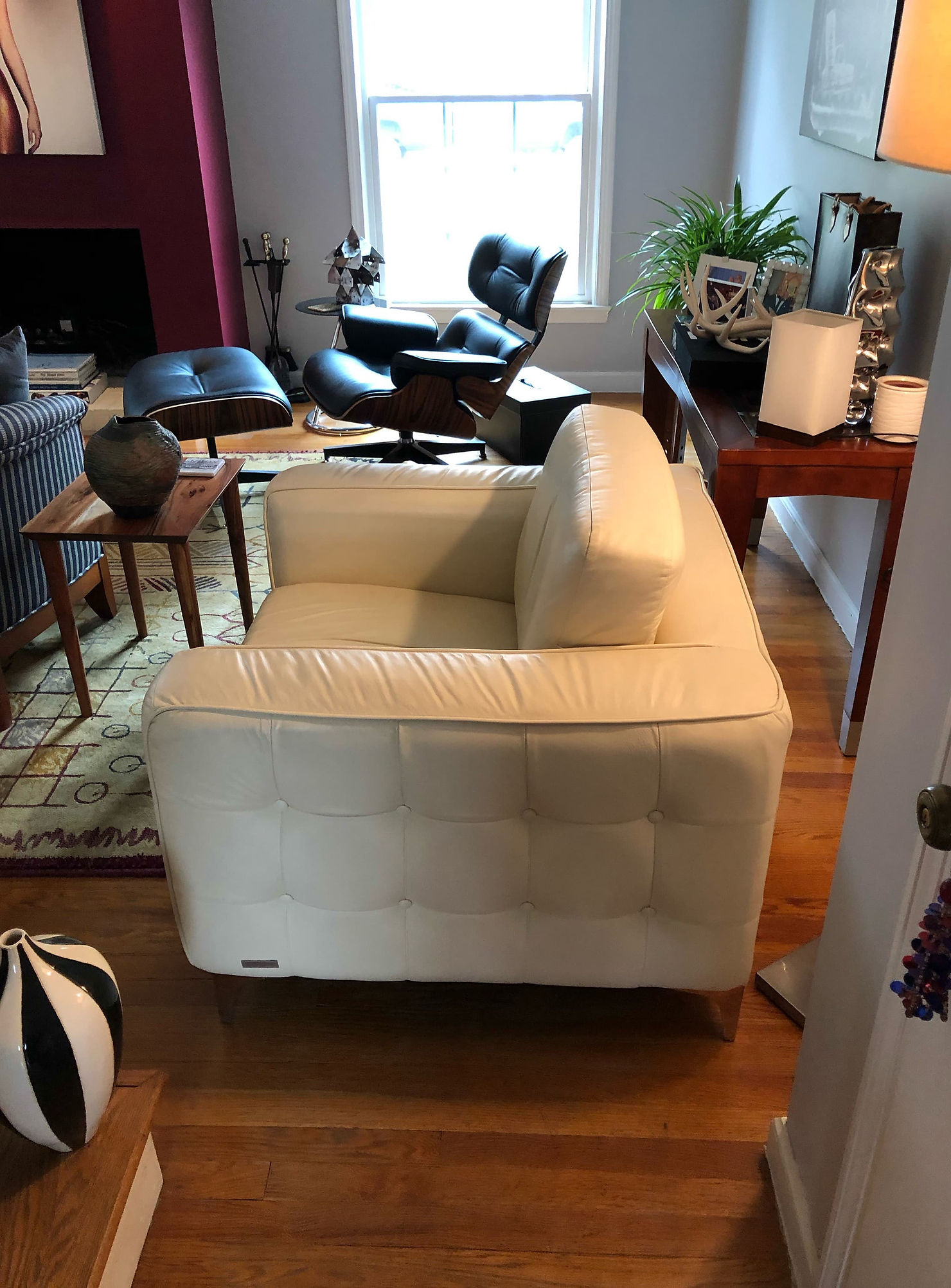 Oversized white chair overwhelming a small living room layout before redesign