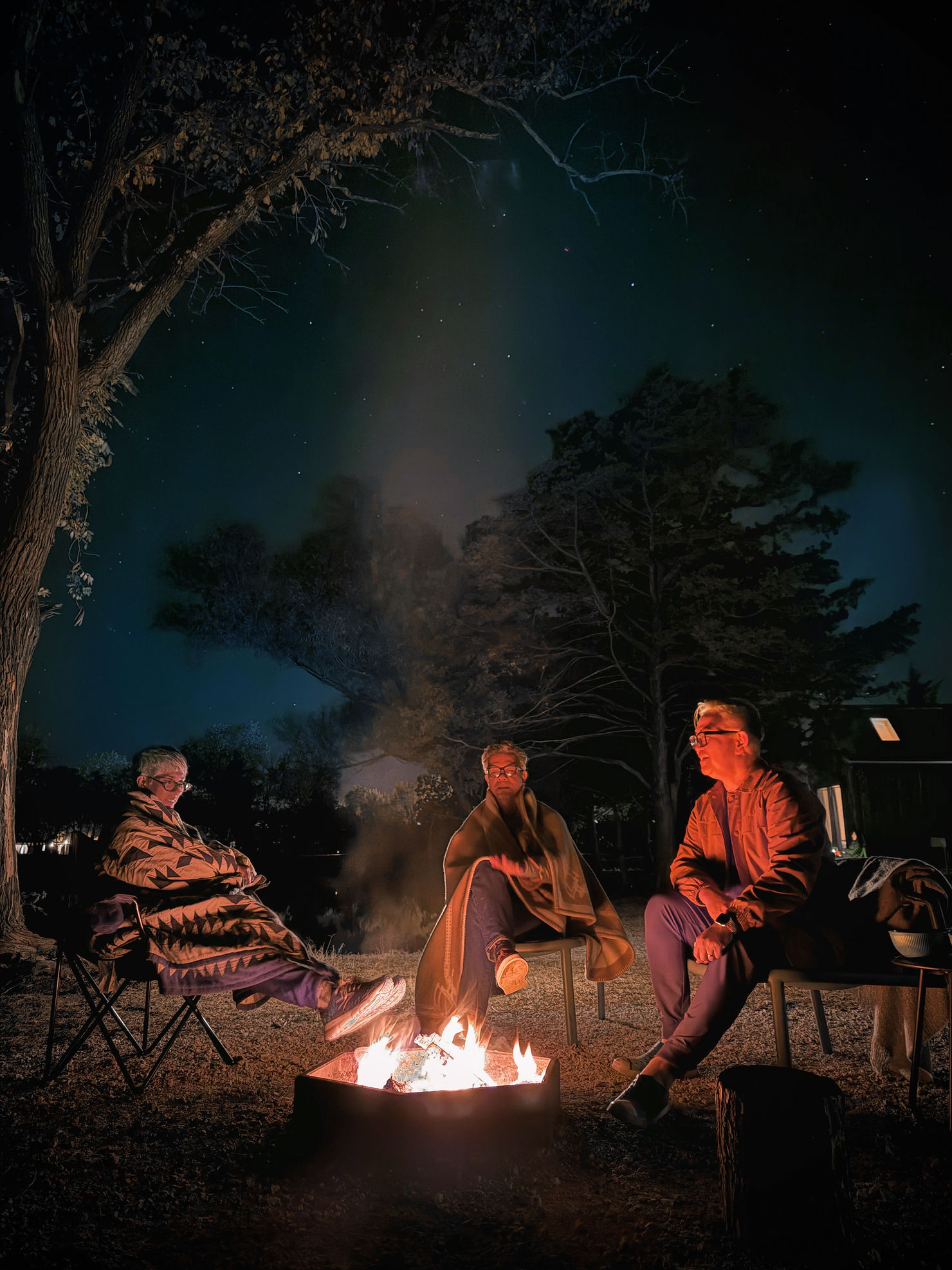Evening campfire gathering with blankets and s’mores under a starry sky