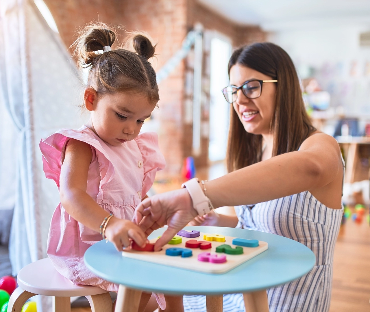An ABA professional happily working with a young child.