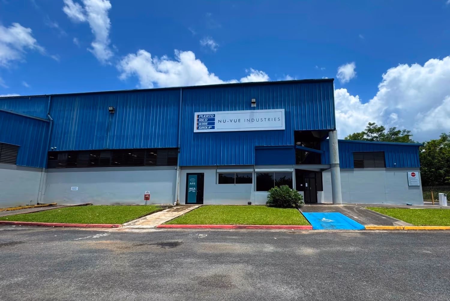 Exterior of Nu-Vue Industries facility in Puerto Rico, acquired in 2016 by Puerto Rico Wire Group to expand expertise in metal roofing, storm shutters, and structural components.
