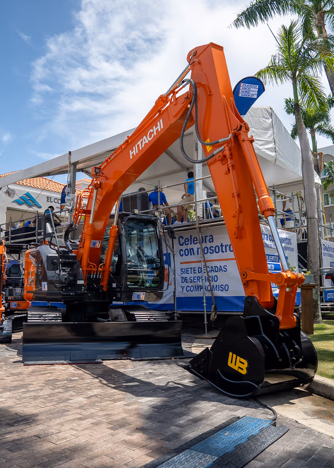 Hitachi construction excavator exhibited by Puerto Rico Wire Group during AGC Puerto Rico 2025 event highlighting heavy equipment solutions