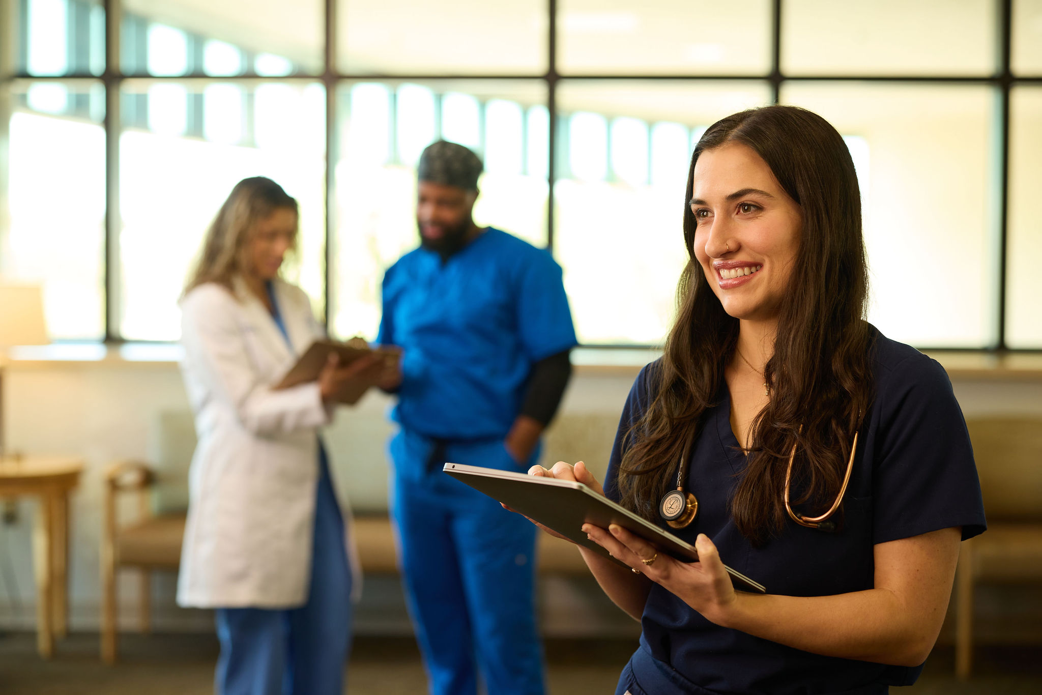 Image of a nurse smiling with a clipboard 