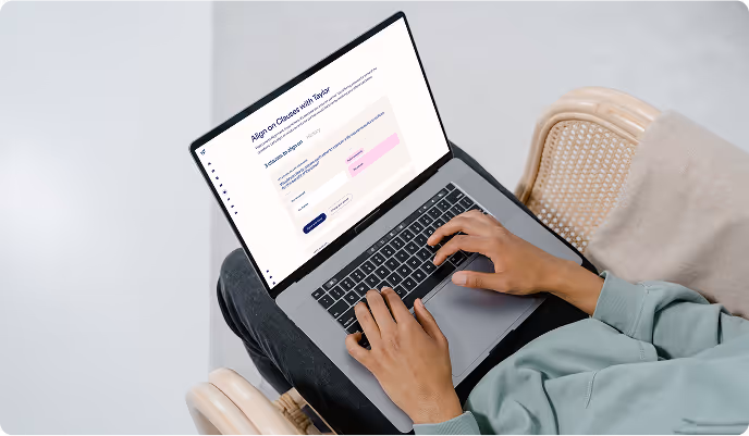 Person seated with a laptop on their lap typing on the keyboard, displaying a webpage about aligning on causes with Taylor.