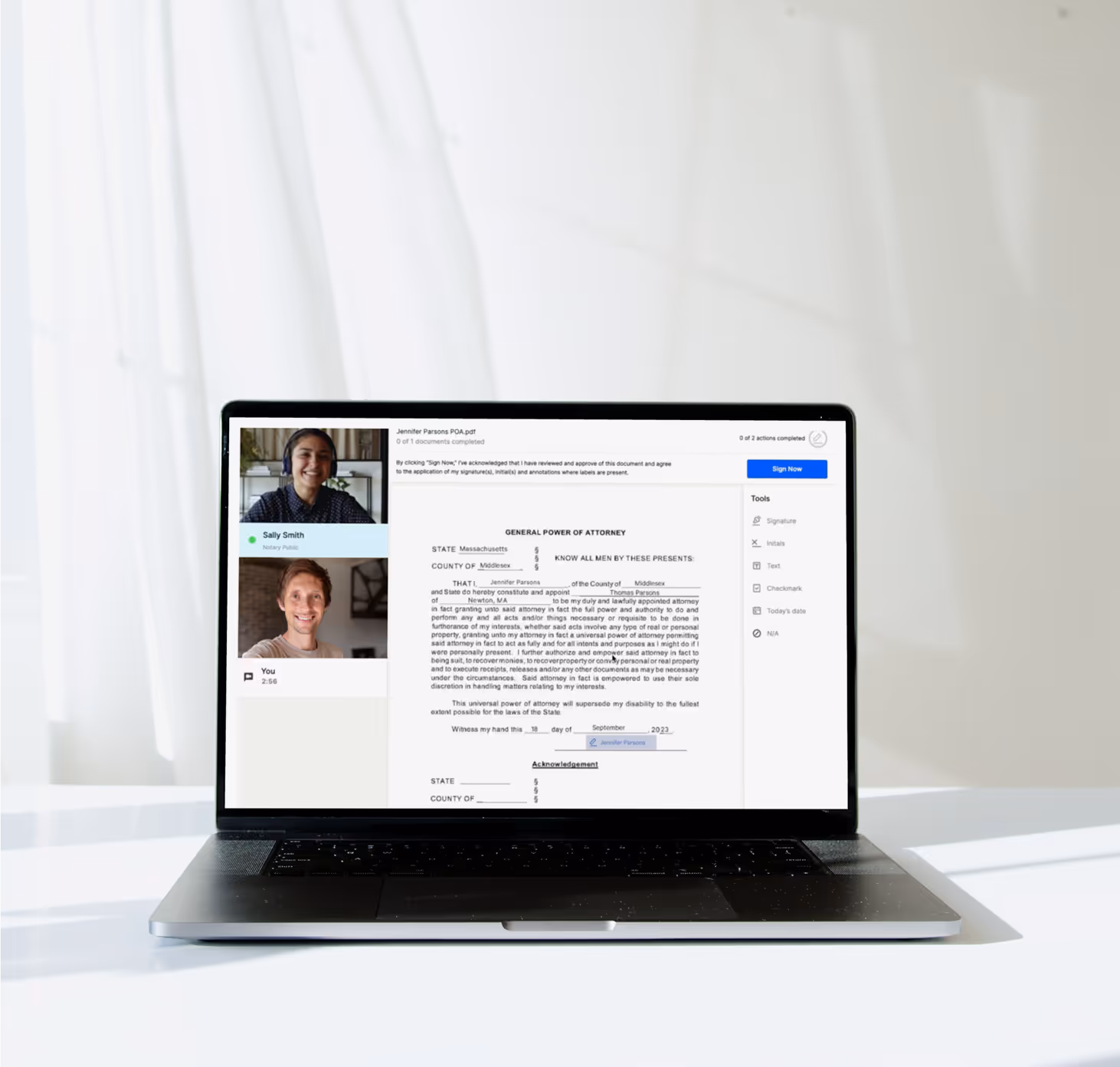 Open laptop on white desk displaying a video call with two people and a document titled 'General Power of Attorney' open on screen.