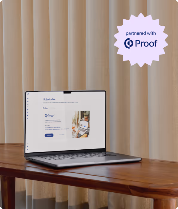 Laptop on wooden table displaying a notarization webpage partnered with Proof, beige curtains in the background.