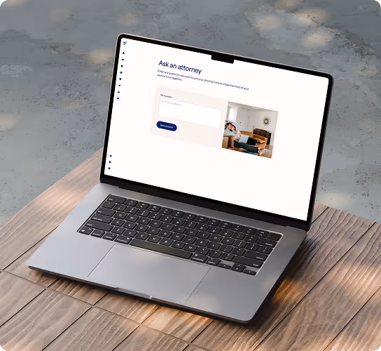 Open laptop on wooden table displaying a website with a form titled 'Ask an attorney' and a photo of a person sitting on a couch with a laptop.