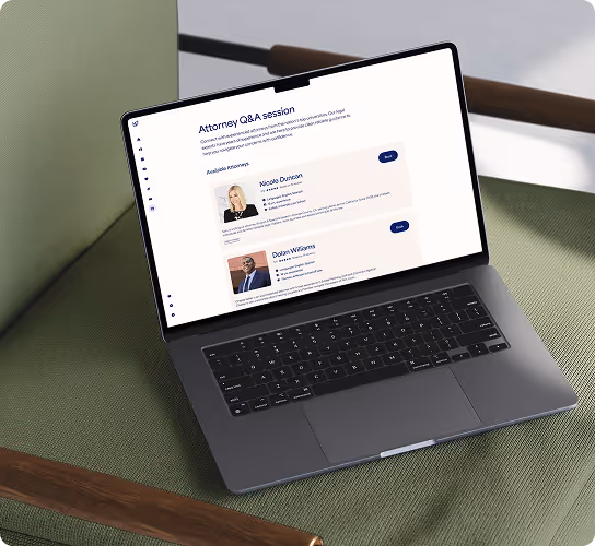 Laptop on a green chair displaying a webpage titled Attorney Q&A session with profiles of two lawyers, Nicole Duncan and Dolan Williams.