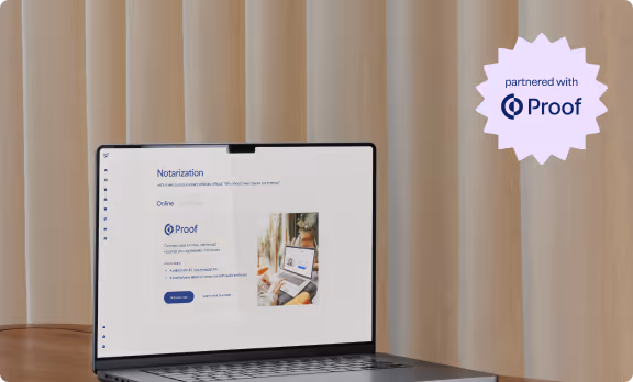 Laptop on a table displaying a notarization service website partnered with Proof, with beige curtains in the background.