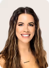 Smiling woman with long wavy brown hair wearing a light-colored top against a beige background.