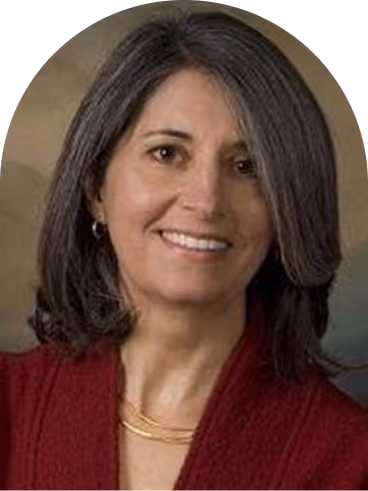 Smiling woman with shoulder-length dark hair wearing a red top and gold necklace.