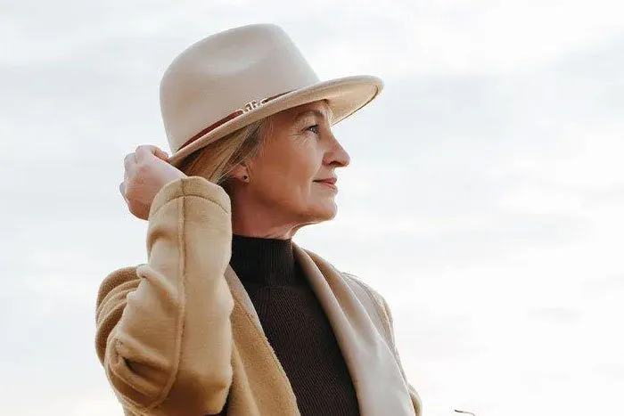 Well dressed woman standing by the pier.