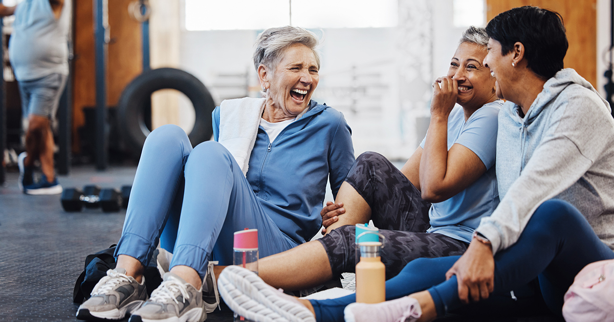 Mature women at the gym laughing together
