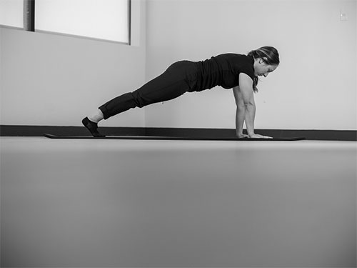 Woman performing a plank on her hands.