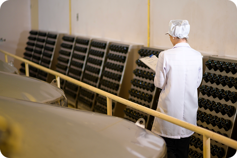 Quality inspector recording information on a clipboard in a processing facility, representing the risks of paper, Word and Excel based food safety documentation highlighted in the blog.