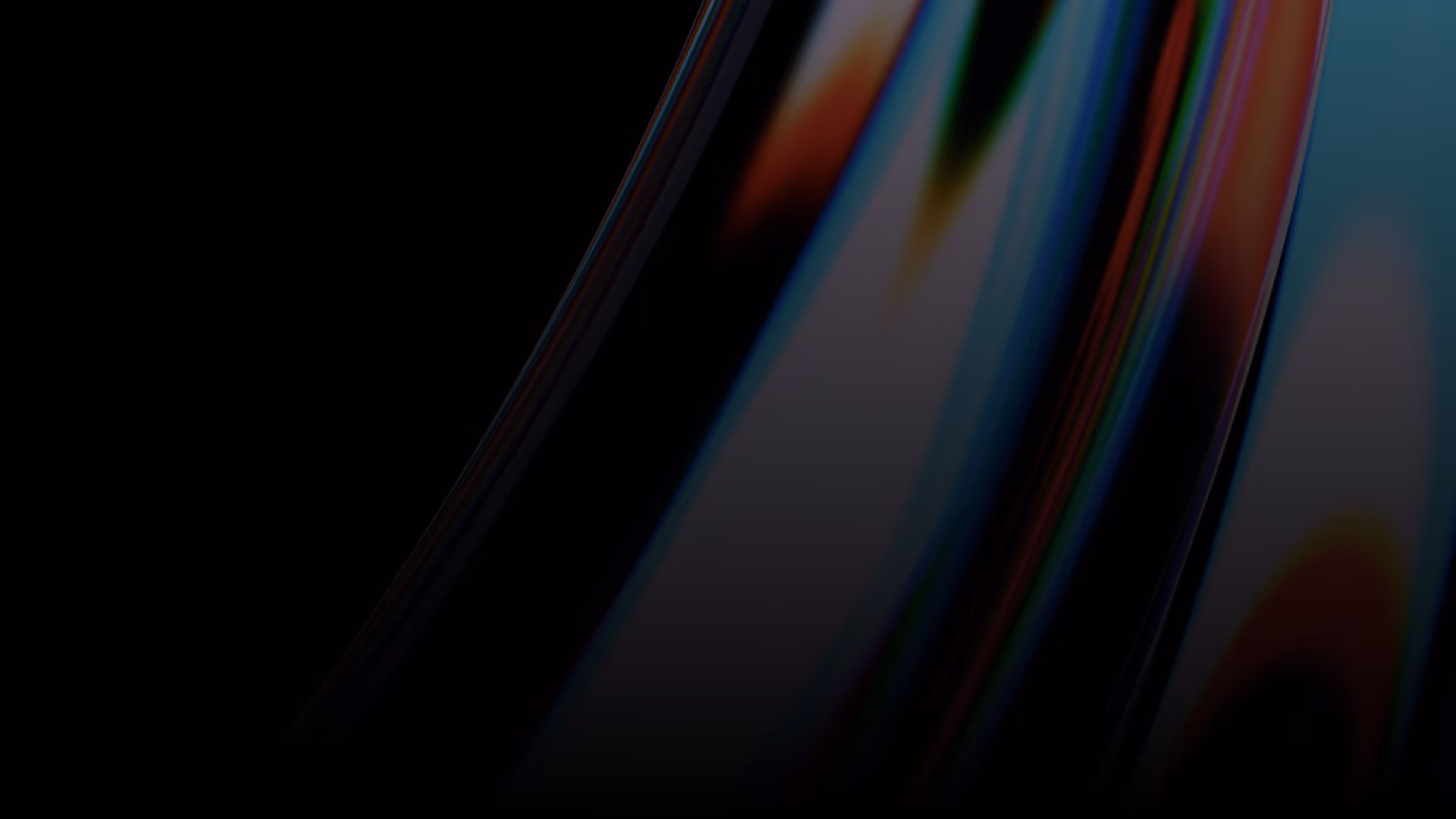 Abstract close-up of dark, glossy surface with streaks of blue, red, and orange light reflections.